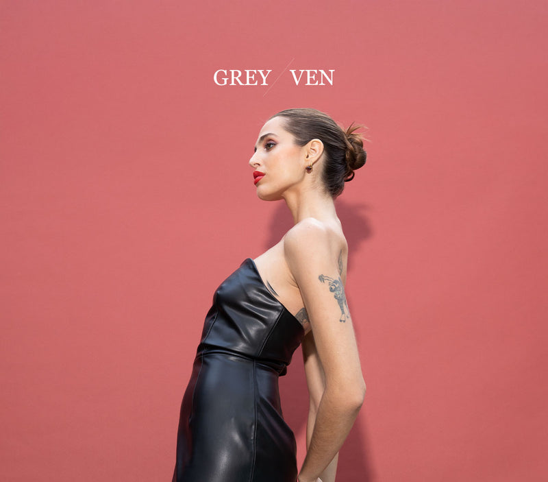 Side profile of a model in a vegan leather strapless dress for Grey Ven