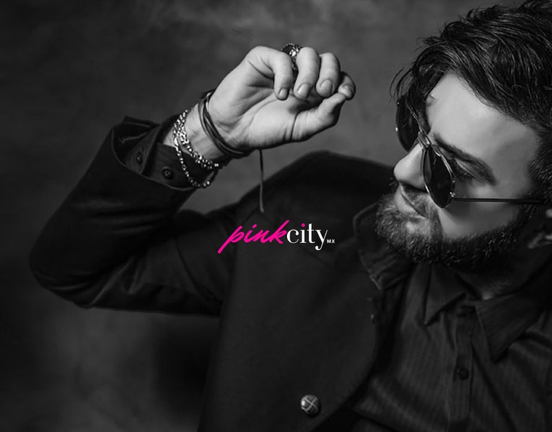 Pink City banner image with a man in a black shirt and dark sunglasses