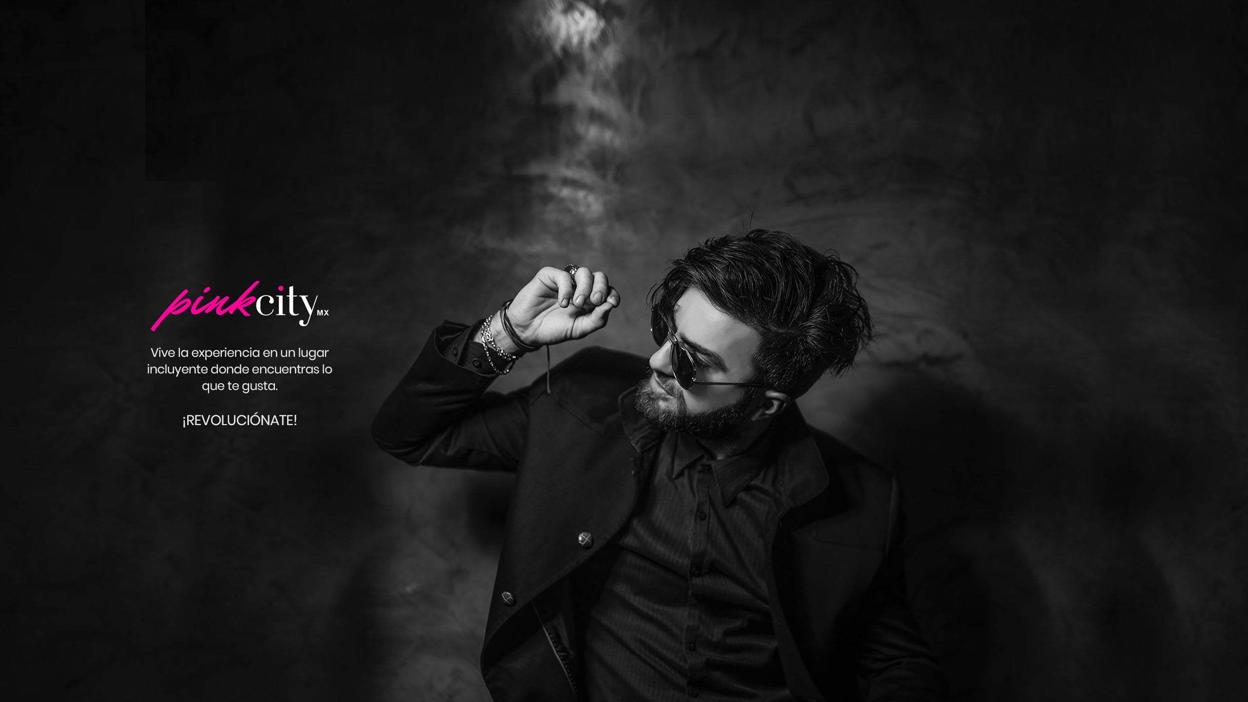 Pink City banner image with a man in a black shirt and dark sunglasses